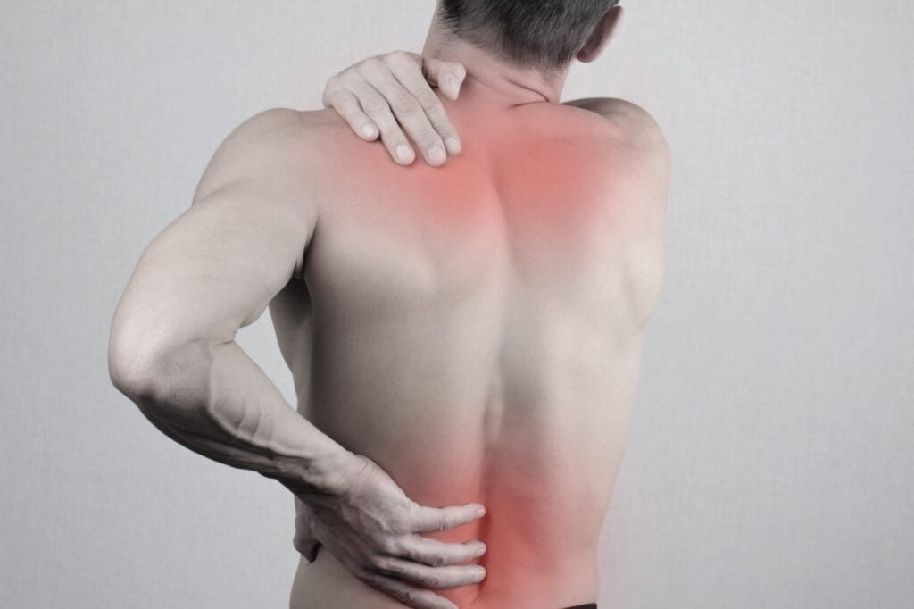 Man with neck and back pain. Man rubbing his painful back close up. Pain relief concept