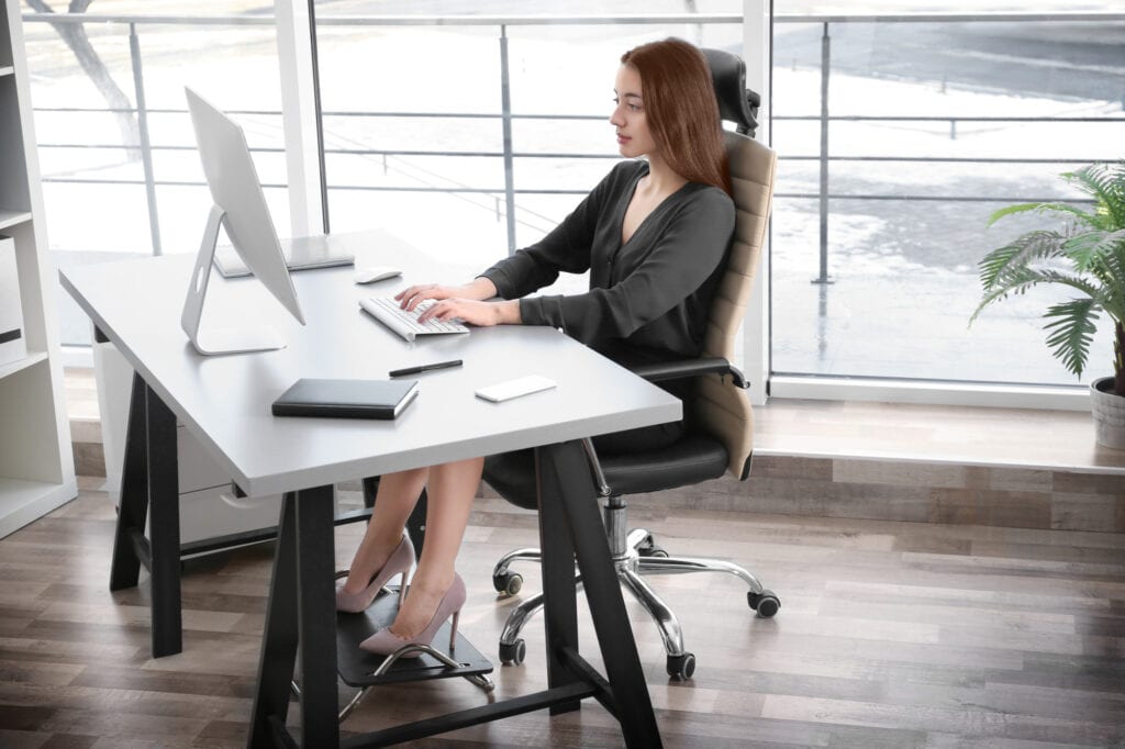 Posture concept. Young woman working with computer at office